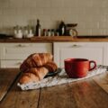 croissants and a cup of coffee on a kitchen table